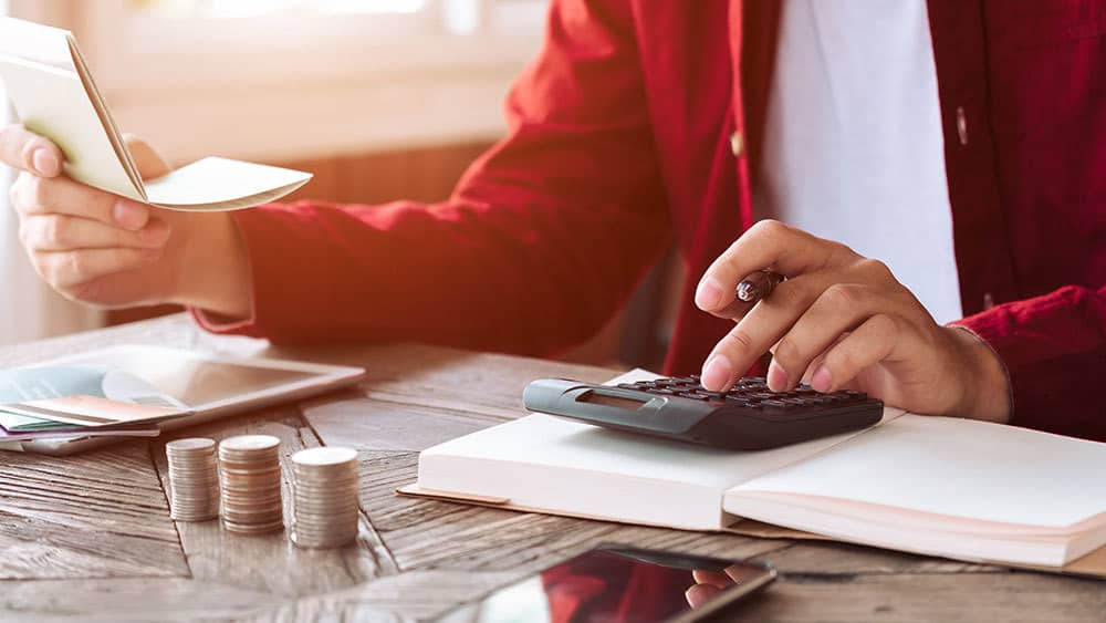 a man calculating hvac maintenance costs 