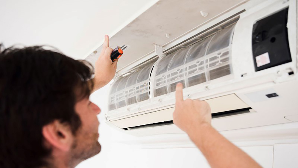 Man repairing Air Conditioner Smells