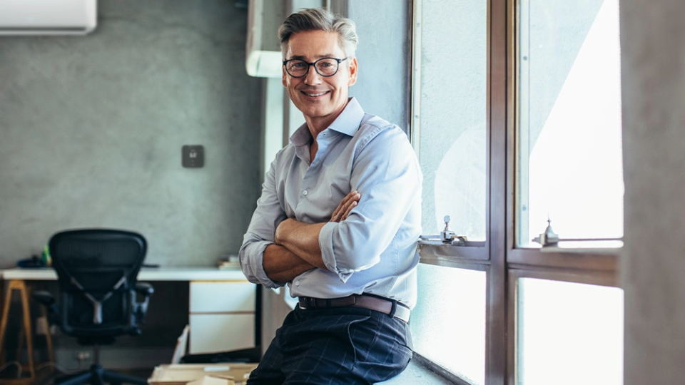 A man smiling. breez max can be seen in the background