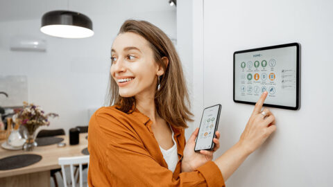 woman controlling smart home appliances through smart home hub