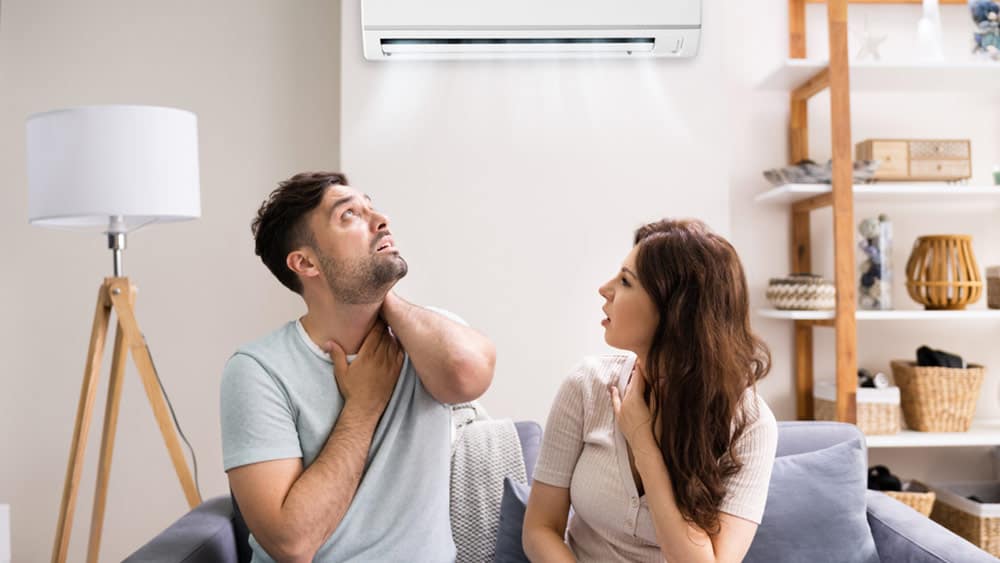 A man and a woman seem distresse due to their AC not working