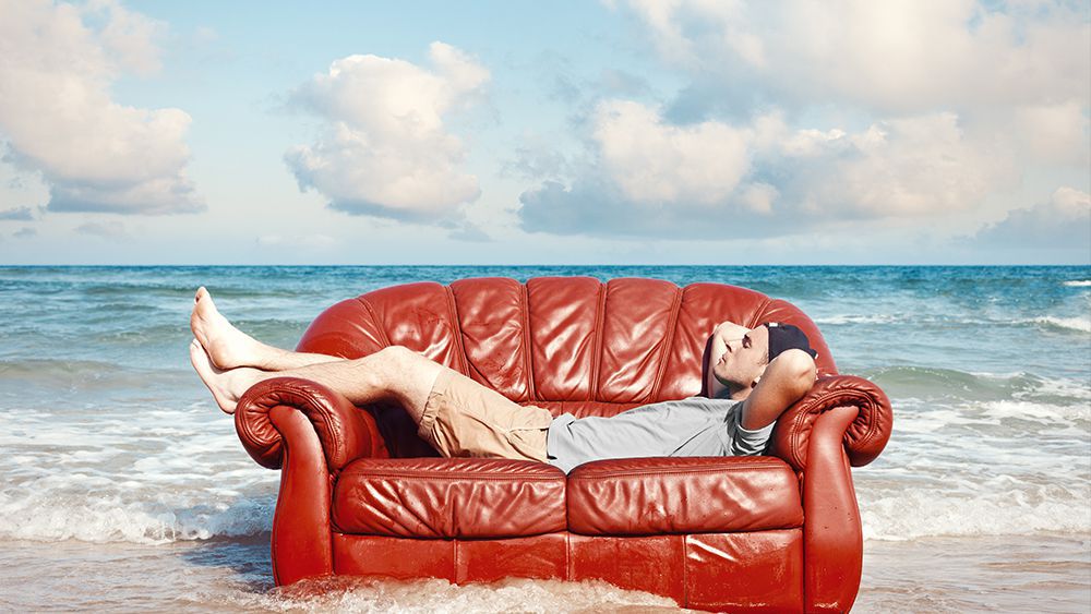 Man relaxing on sofa - How to stay cool without AC