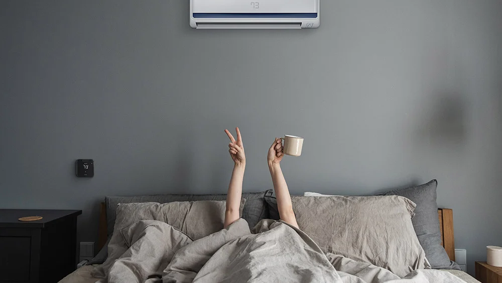 Woman enjoying morning coffee with breez max controlling room temperature