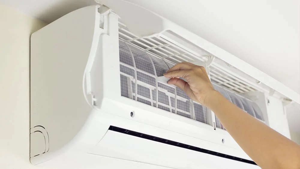 A man cleaning AC filters