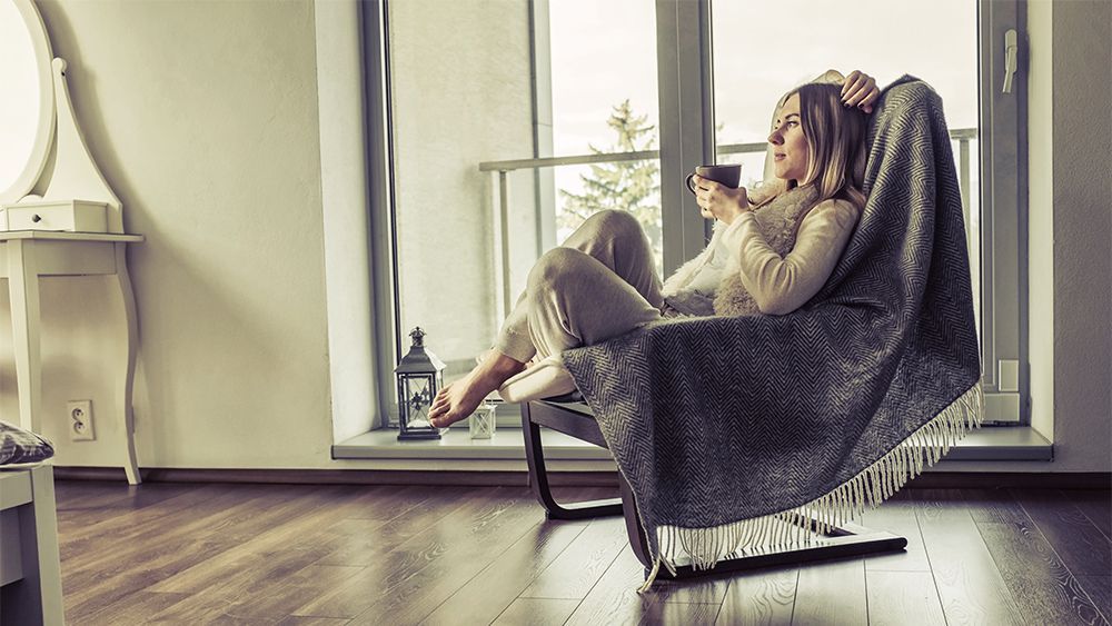 Woman relaxing in an arm chair