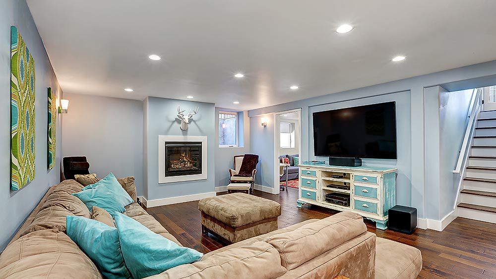 A warm, cozy basement with an indoor fireplace