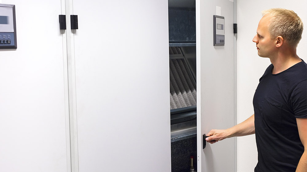 Man opening a cabinet in server room