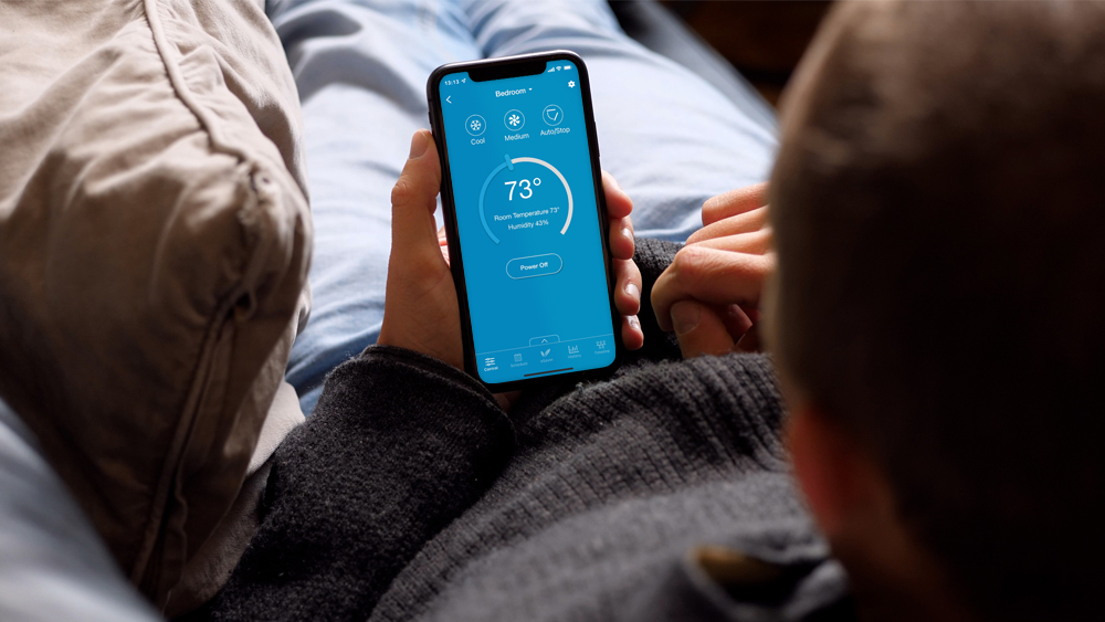 A man using cielo home app to change temperature settings