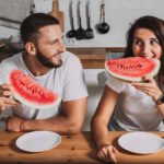 Man and woman enjoying water melon in summer season