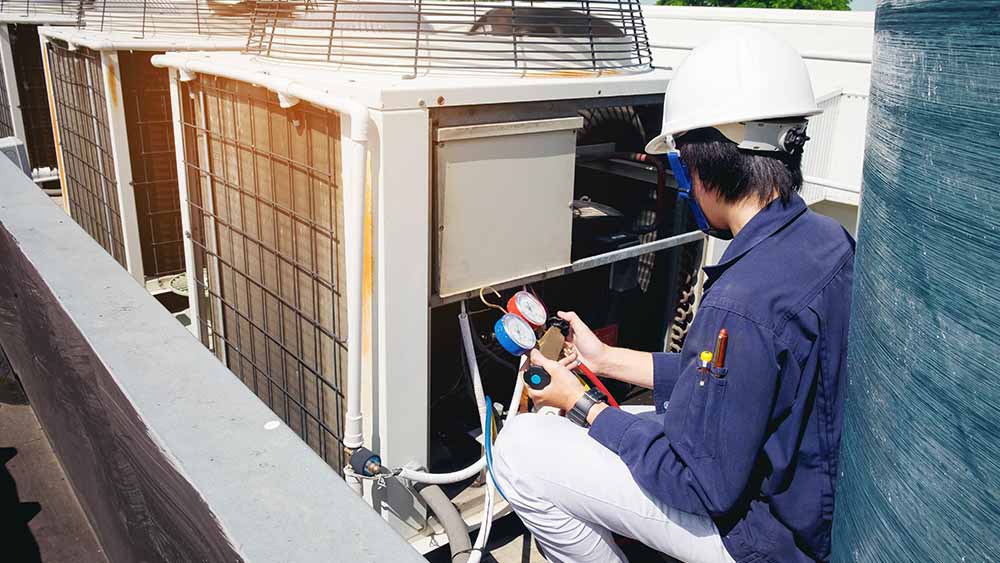 HVAC technician checking refrigerant levels