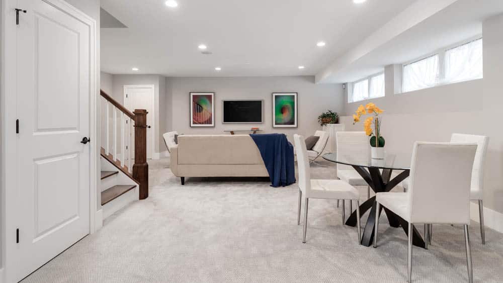 A nicely decorated living room in a basement