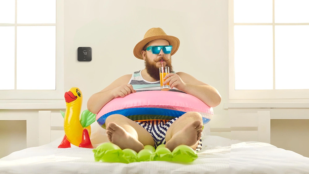 A person enjoying summer as Comfy mode in Cielo Breez smart AC controllers maintain ideal temperature 