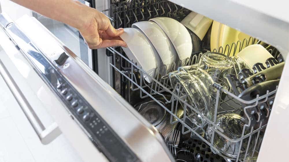 Person unloading a dishwasher