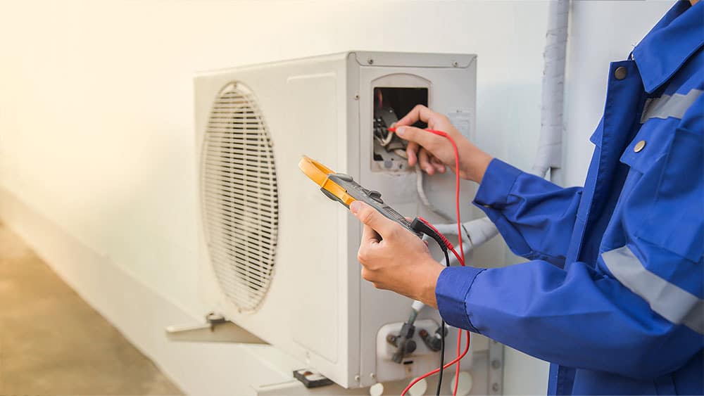 A repairman fixing mini-split heat pump