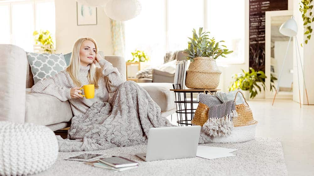 woman enjoying fall season with a warm cup of coffee