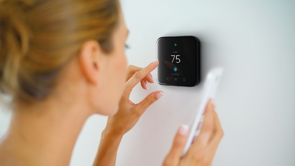 Woman connecting her Cielo smart thermostat to her phone