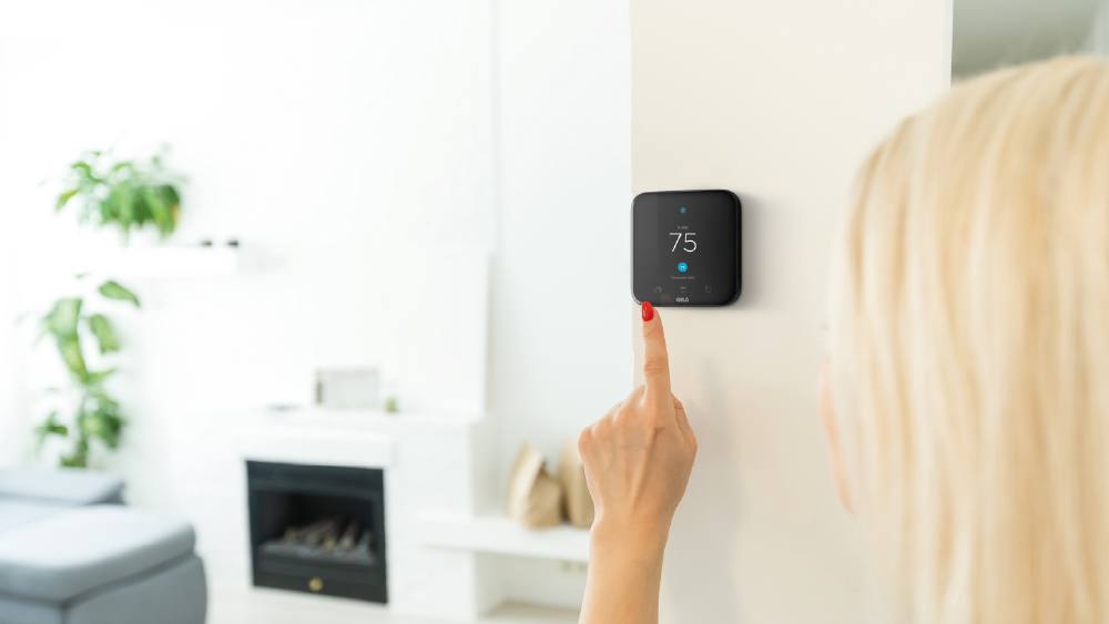 woman making temperature changes on her cielo smart thermostat