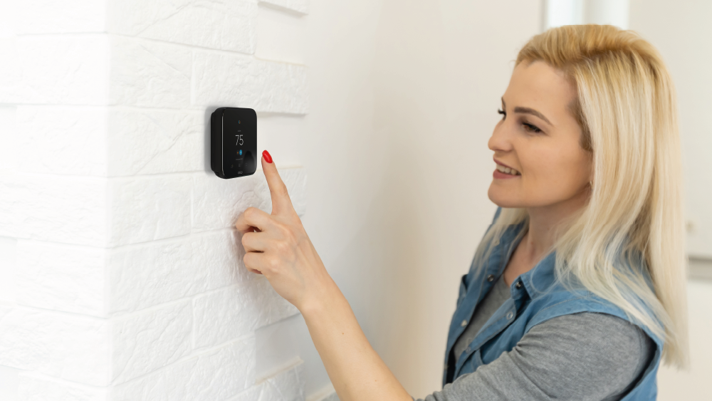 Woman using Cielo smart thermostat 