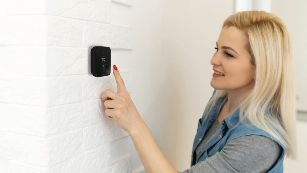 Woman using Cielo smart thermostat