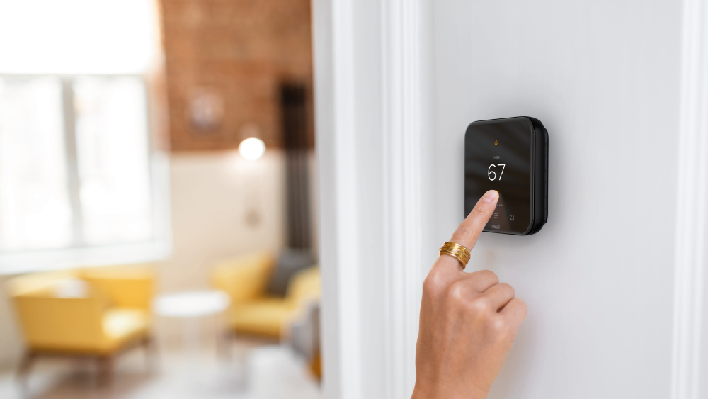 A person adjusting temperature on Cielo Smart Thermostat.