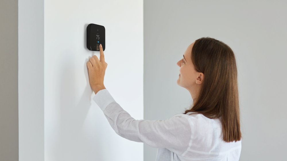 girl setting vacation mode on her Cielo smart thermostat