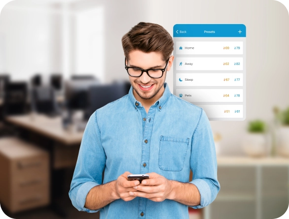 A man using Cielo smart thermostat presets on Cielo home app.