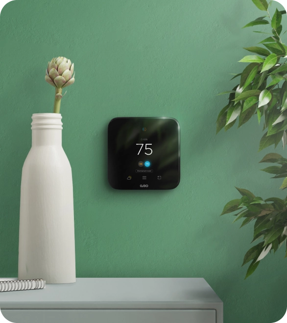 Cielo smart thermostat on a green wall