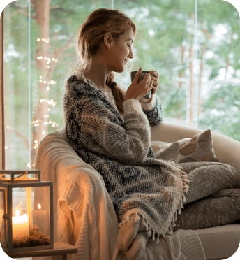 Woman sitting on a couch, drinking coffee
