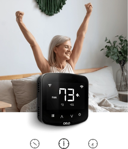 Woman waking up to her preferred temperature as Cielo Breez plus implements her morning schedule.