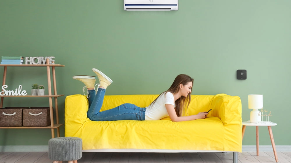 A woman using cielo home app to adjust her temperature settings