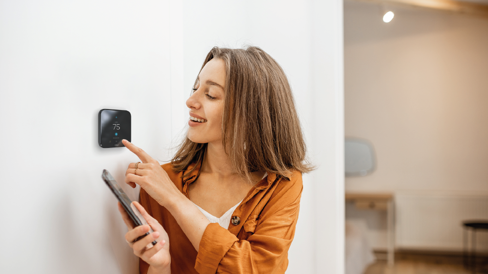 woman changing thermostat settings 