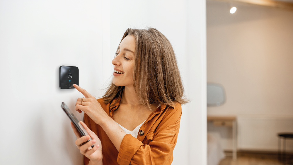 woman changing thermostat settings