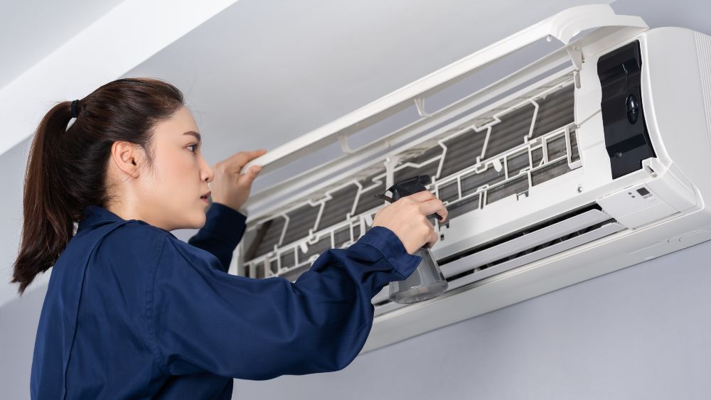 woman hvac technician cleaning AC filters 