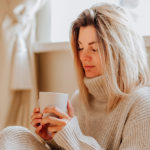 woman sitting and drinking warm tea
