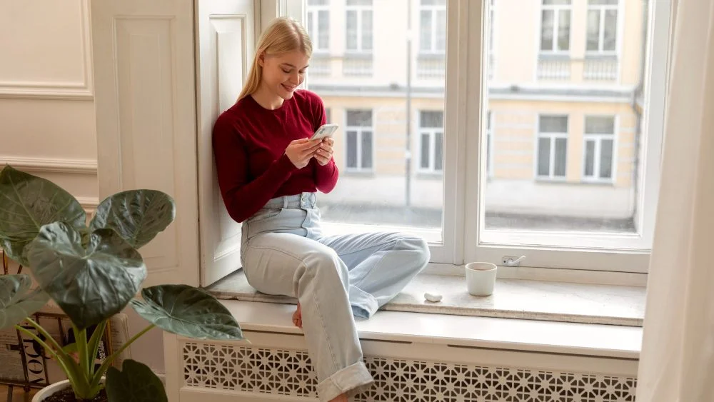 woman-sitting-in-front-of-vertical-window