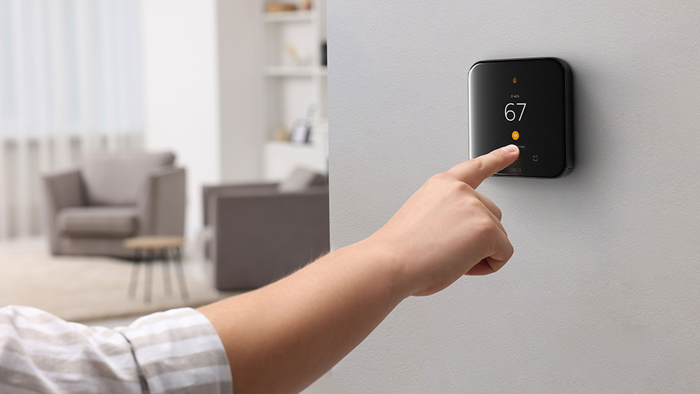 a person adjusting hold settings on cielo smart thermostat