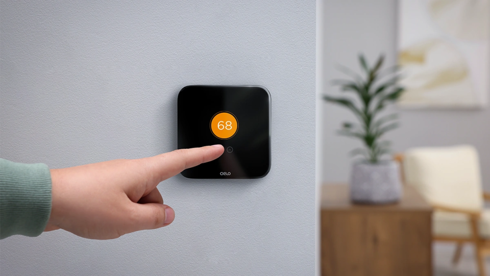 a person changing temperature settings on cielo smart thermostat