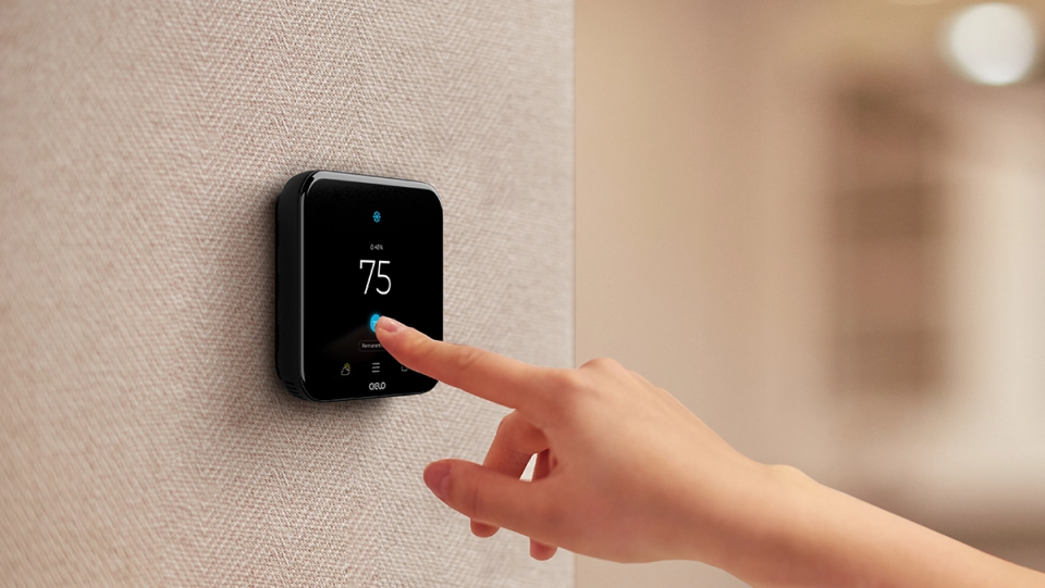 a person adjusting temperature on cielo smart thermostat