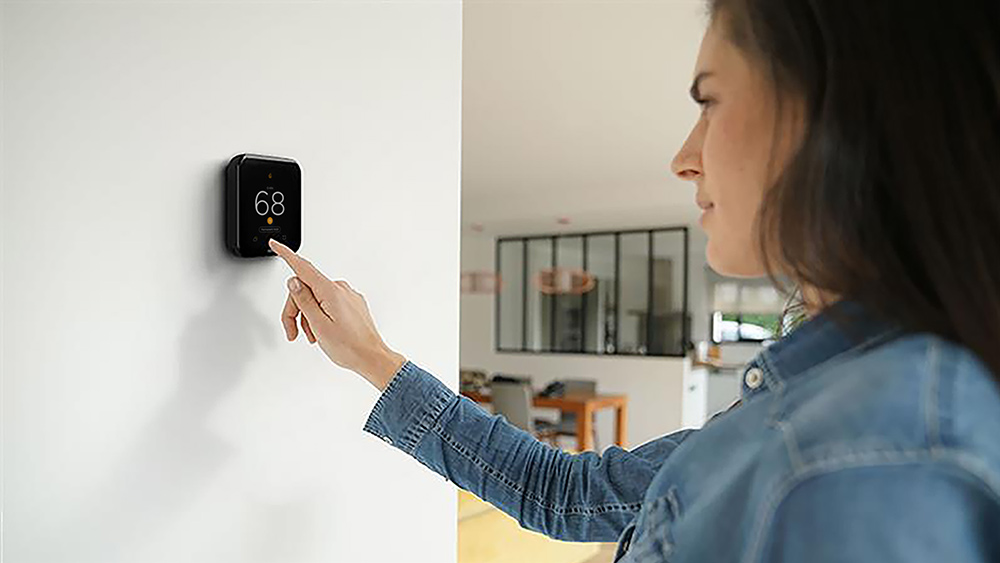 A person adjusting temperature on cielo smart thermostat