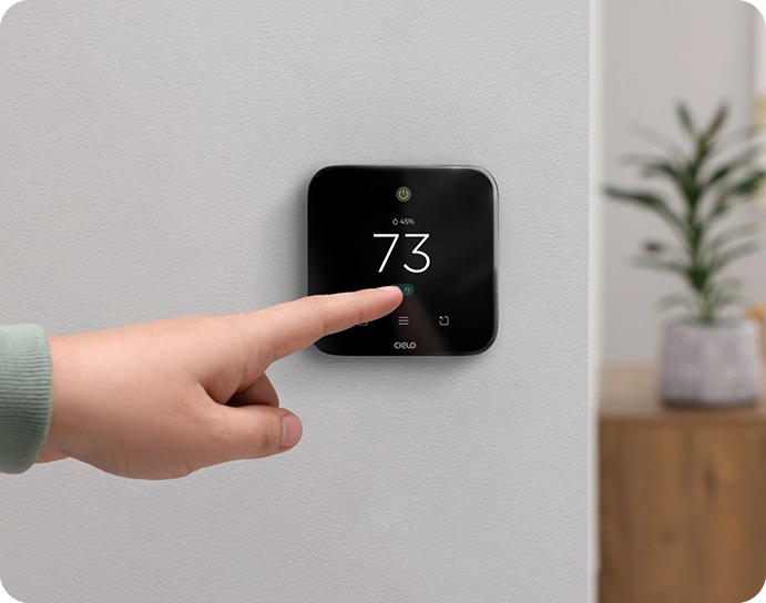 A person adjusting temperature on breez edge 